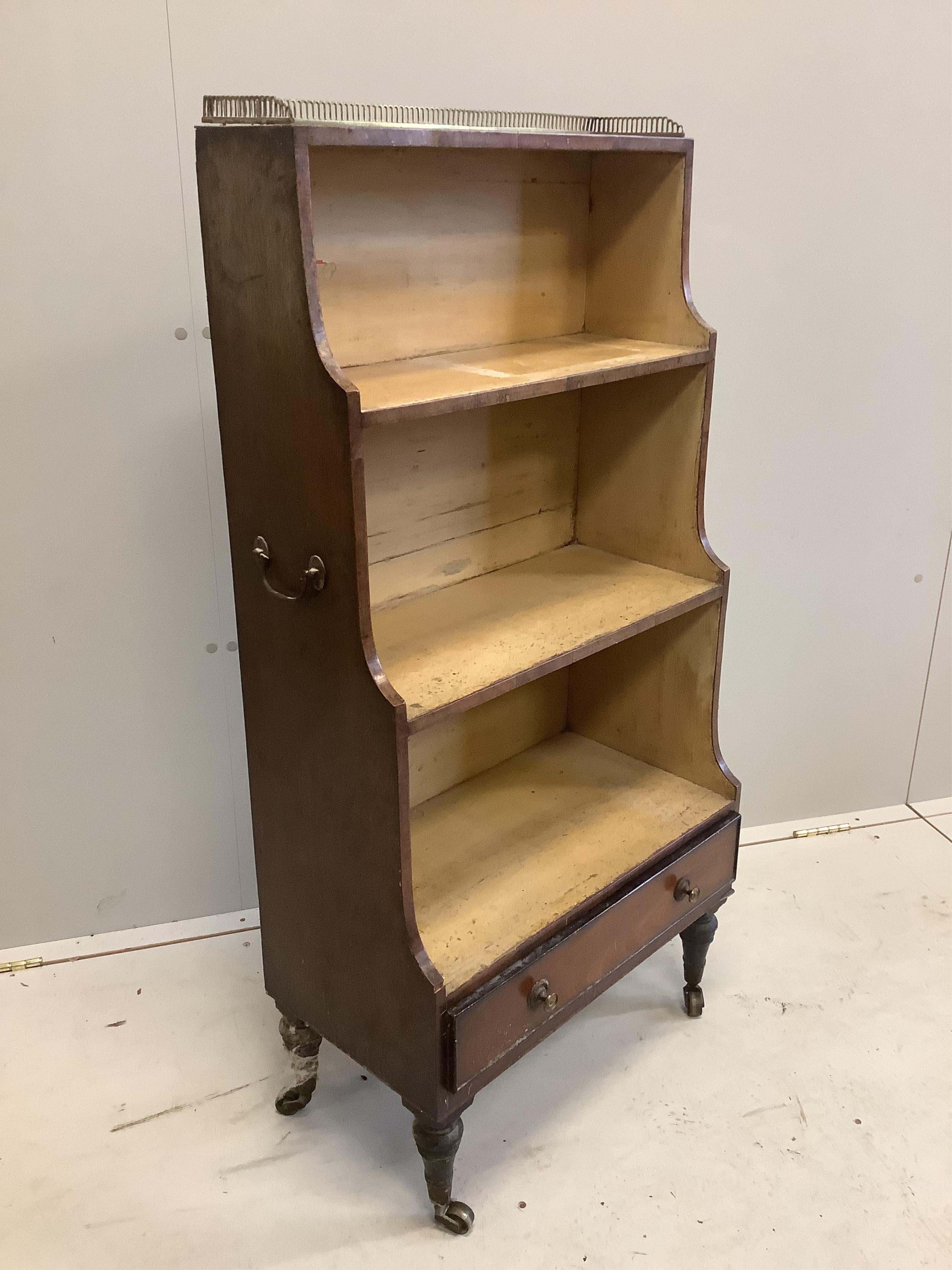 A Regency mahogany dwarf open bookcase, with three quarter brass gallery, width 56cm, depth 30cm, height 115cm. Condition - poor to fair